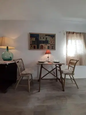 a dining room with a table and two chairs at Ático Baños del Carmen in Cádiz