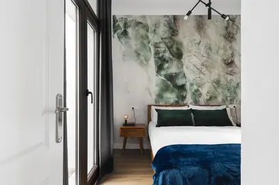 a bedroom with a bed and a painting on the wall at Apartamento San Juan, Parking privado in Jerez de la Frontera