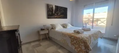 a bedroom with a bed in a room with a window at ARENA & SOUL SUITe in El Puerto de Santa María