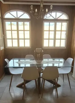 a dining room with a glass table and chairs at ARENA & SOUL SUITe in El Puerto de Santa María