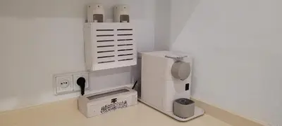 a small kitchen with a refrigerator and a box at ARENA & SOUL SUITe in El Puerto de Santa María