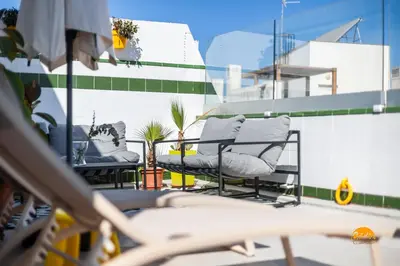 a couple of chairs sitting on top of a balcony at Atico Catedral by Cadiz Time in Cádiz