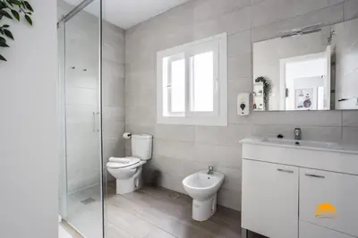 a bathroom with a toilet and a sink and a shower at Atico Catedral by Cadiz Time in Cádiz