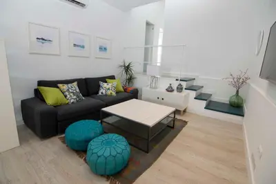a living room with a couch and a table at Casa Izaro in Sanlúcar de Barrameda