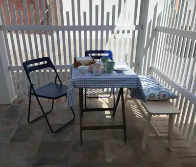 a table with two chairs and a blue and white table cloth at Casa Izaro in Sanlúcar de Barrameda