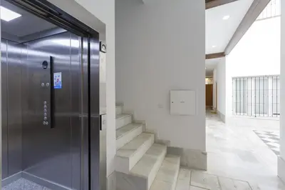 a hallway with a door and stairs in a building at COLON15 Family Home by Cadiz4Rentals in Cádiz