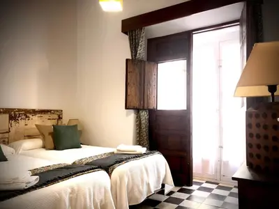 a bedroom with a bed and a window at La Alberca de Fariñas in Sanlúcar de Barrameda