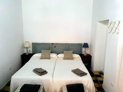 a bedroom with a bed with two pillows on it at La Alberca de Fariñas in Sanlúcar de Barrameda