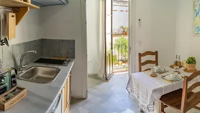 a kitchen with a sink and a table with a tableablish at La Alberca de Fariñas in Sanlúcar de Barrameda