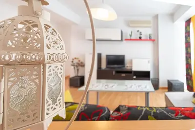 a living room with a table with a lantern at Apartamento las Jacarandas de Cadiz in Cádiz