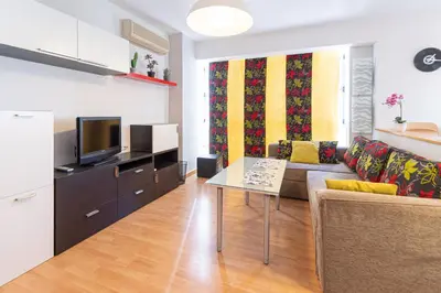 a living room with a couch and a table at Apartamento las Jacarandas de Cadiz in Cádiz