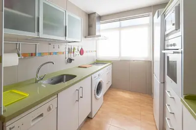 a kitchen with a sink and a washing machine at Apartamento las Jacarandas de Cadiz in Cádiz