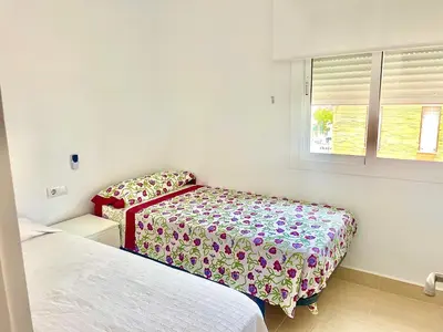 a bedroom with two beds and a window at vistas maravillosas in Chipiona