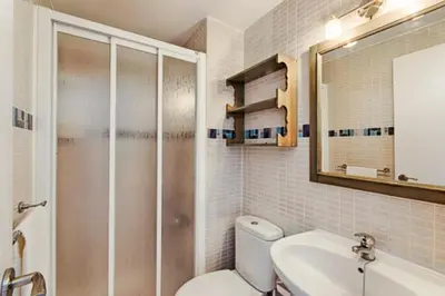 a bathroom with a toilet and a sink and a mirror at vistas maravillosas in Chipiona