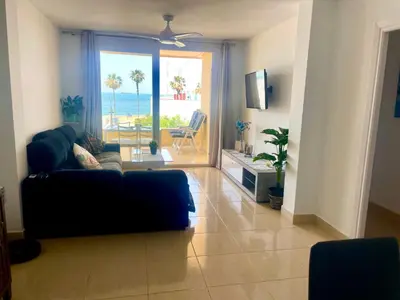 a living room with a couch and a view of the ocean at vistas maravillosas in Chipiona