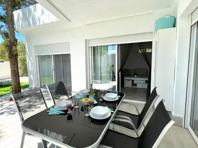 a dining room with a black table and chairs at Minichalet El Molino 5 in Chiclana de la Frontera