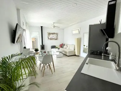 a living room with a kitchen and a living room with a couch at Minichalet El Molino 5 in Chiclana de la Frontera