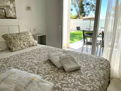 a bedroom with a bed with two pillows on it at Minichalet El Molino 5 in Chiclana de la Frontera