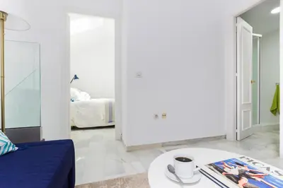 a living room with a bed and a coffee table at Duplex Terraza Rivera Marisco 2 Dormitorios 2 Baños in El Puerto de Santa María