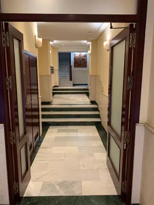 a hallway of a hotel with doors and stairs at El mirador de Ancha in Cádiz