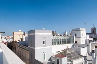a view of the roofs of buildings in a city at El mirador de Ancha in Cádiz