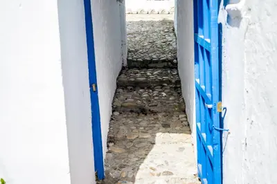 an open door with a stone walkway leading into a building at CASA PACO - Casita con Encanto in Medina Sidonia