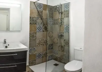 a bathroom with a shower and a toilet and a sink at CASA PACO - Casita con Encanto in Medina Sidonia