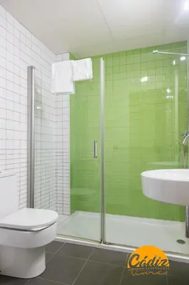 a bathroom with a shower and a toilet and a sink at Apartamento Caleta - FREE PARKING by Cadiz Time in Cádiz