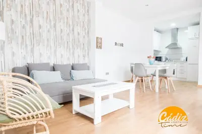 a living room with a couch and a table at Apartamento Caleta - FREE PARKING by Cadiz Time in Cádiz