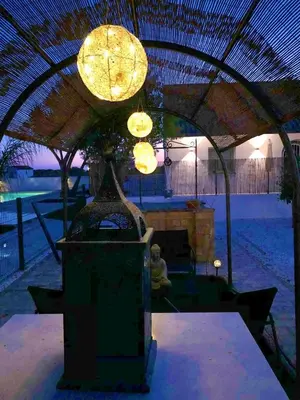 a lit up patio with a table and lights at Villas Santa Ana in Conil de la Frontera