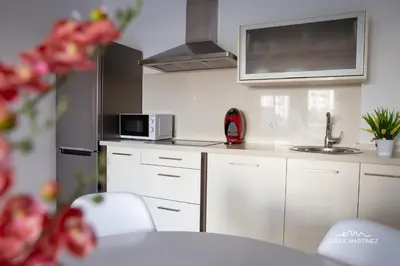 a white kitchen with a sink and a microwave at Apartamento Cañadilla MRZ Rentals in El Puerto de Santa María
