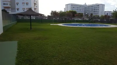 a park with an umbrella in the grass at Apartamento Cañadilla MRZ Rentals in El Puerto de Santa María