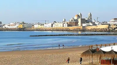 a view of a beach with a city in the background at Sunset Caleta in Cádiz