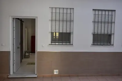 a hallway of a building with two windows at Sunset Caleta in Cádiz