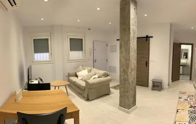 a living room with a couch and a table at Sunset Caleta in Cádiz