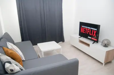 a living room with a couch and a tv at El mirador de Ancha in Cádiz