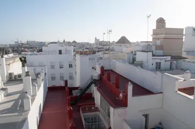 a view of a city from the roofs of buildings at El mirador de Ancha in Cádiz