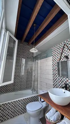 a bathroom with a sink and a toilet and a tub at El ático de los mosaicos in Cádiz