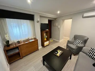 a living room with a couch and a table at Lemon Tree Corazón de Cádiz Grupo AC Gestion in Cádiz