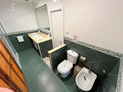 a bathroom with a toilet and a sink at Lemon Tree Corazón de Cádiz Grupo AC Gestion in Cádiz