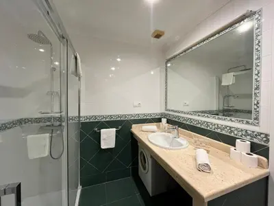 a bathroom with a sink and a shower at Lemon Tree Corazón de Cádiz Grupo AC Gestion in Cádiz