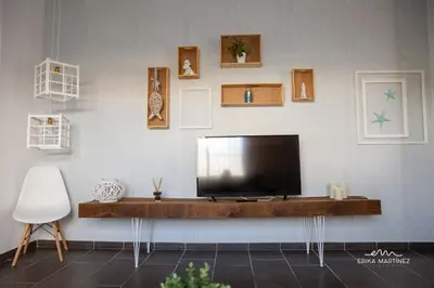 a living room with a flat screen tv on a wall at Apartamento Lapa MRZ Rentals in El Puerto de Santa María