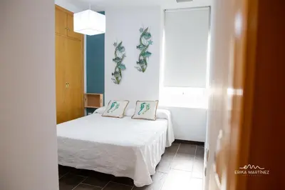 a bedroom with a bed with two pillows on it at Apartamento Lapa MRZ Rentals in El Puerto de Santa María