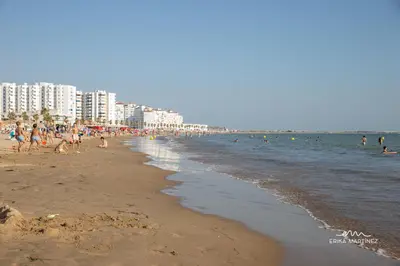 a beach with a lot of people in the water at Apartamento Lapa MRZ Rentals in El Puerto de Santa María