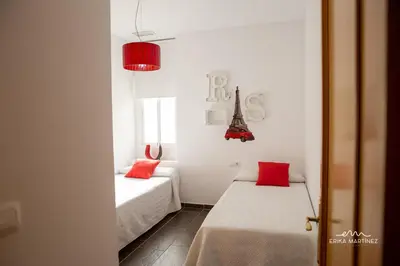 a small room with two beds and the eiffel tower at Apartamento Lapa MRZ Rentals in El Puerto de Santa María