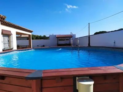 a large swimming pool in the backyard of a house at La Guareña in Chiclana de la Frontera