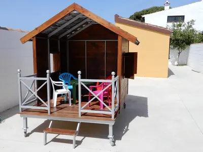 a dog house with two chairs in it at La Guareña in Chiclana de la Frontera