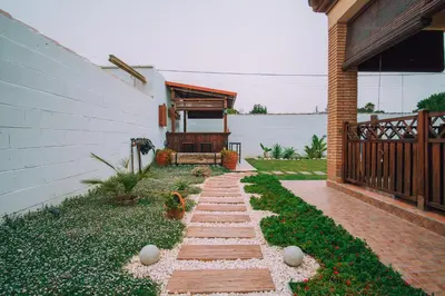 a garden with a walkway next to a house at La Guareña in Chiclana de la Frontera