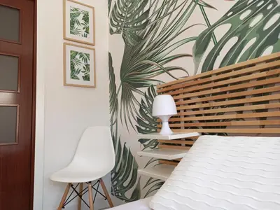 a bedroom with a bed and two white chairs at Viña 41 in Cádiz