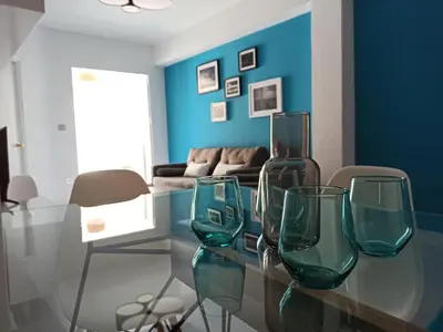 four wine glasses sitting on a glass table in a living room at Viña 41 in Cádiz